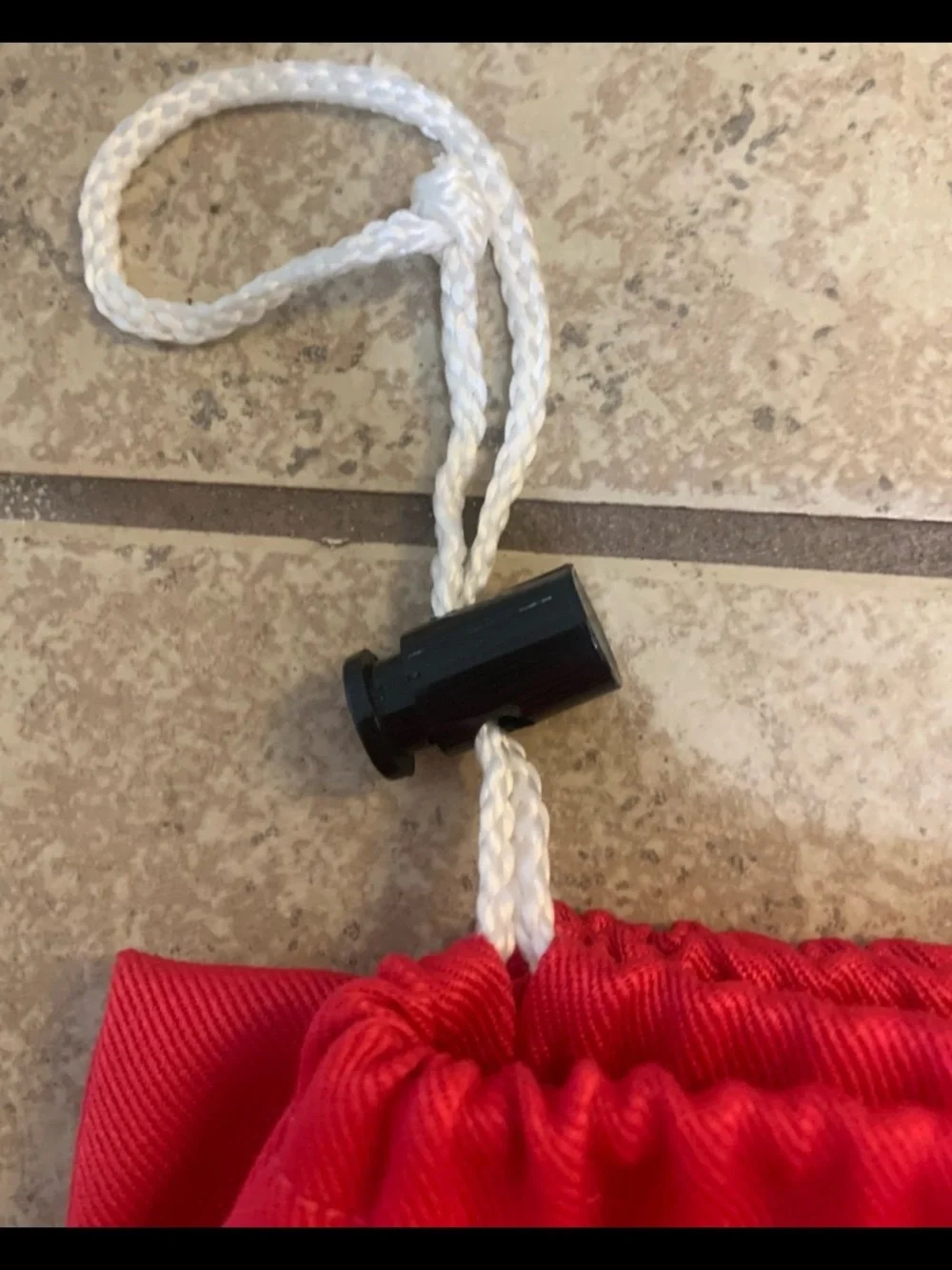 Solid Red Drawstring Laundry Bag. Made of Fabric and White drawstring closure.